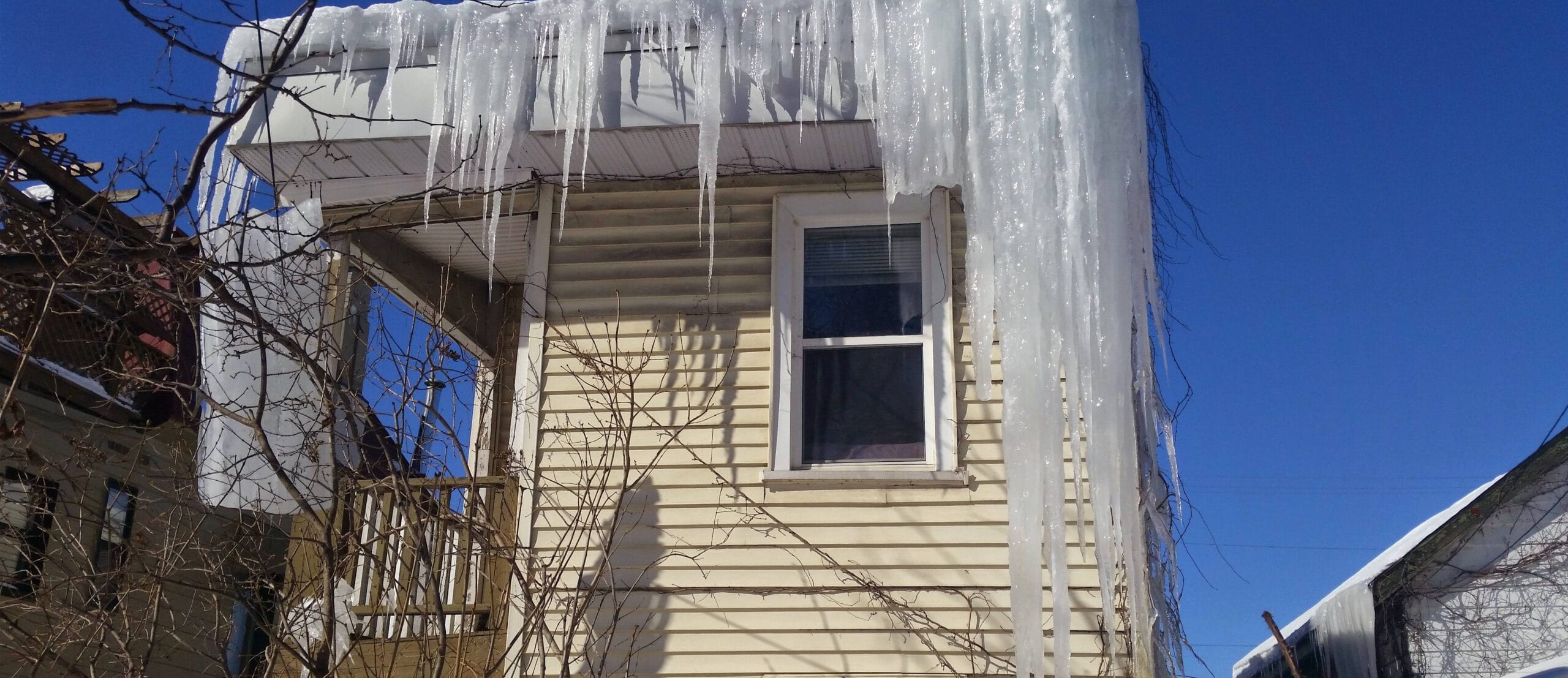 Ice dam forming along the edge of a snow-covered roof